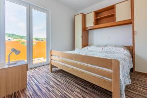 Postel nebo postele na pokoji v ubytování Apartments Lino