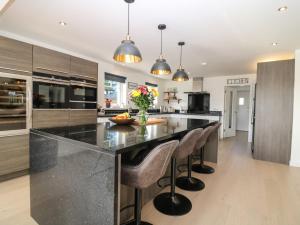 a kitchen with a large island with bar stools at Bullpens in Banff