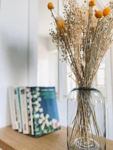 un jarrón con flores en él sentado en una mesa en La Cour Tellier en Rilly-la-Montagne