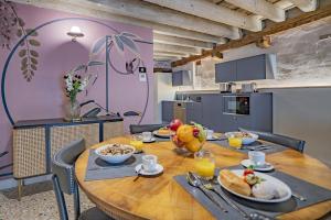 a dining room with a wooden table with food on it at Corte Rubbi 5514 Canal View in Venice