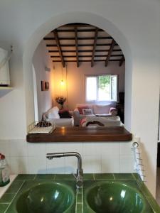 a bathroom with a sink and a living room at Grupoandria Villa Julia in Cala en Forcat