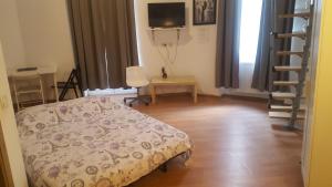 a bedroom with a bed and a desk and a television at Studio Piata Amzei NR.1 (8 B) in Bucharest