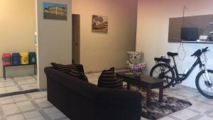 a living room with a couch and a bike on the wall at Bela Vista in São Luís