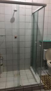 a bathroom with a glass shower with a toilet at Bela Vista in São Luís