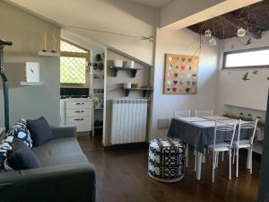 a living room with a couch and a table at Carolina’S Nest in Casal Palocco