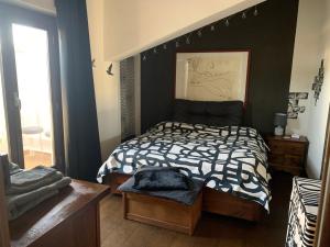 a bedroom with a bed with a black wall at Carolina’S Nest in Casal Palocco