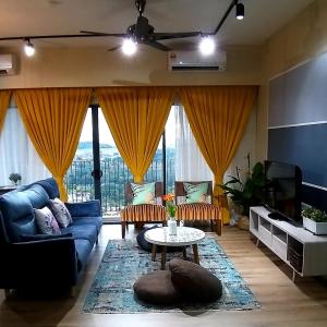 a living room with a blue couch and a tv at Oasisstay 3 Bedrooms Apartment Bangi Sentral in Kampong Sungai Ramal Dalam