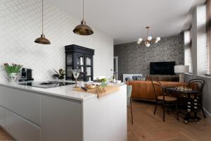 a kitchen and living room with a counter and a dining room at Cathedral Yard - Art Deco Luxury (Exeter) in Exeter