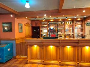 a bar with a large wooden counter in a room at Zajazd Restauracja Machliny in Machliny