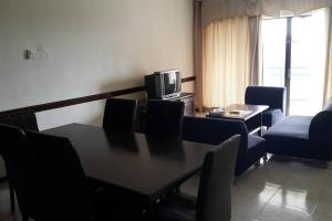 a conference room with a table and chairs and a television at D Savoy 3 Bedroom Condo within Famosa Resort in Kampong Alor Gajah