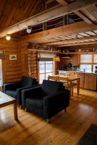 a living room with two couches and a table at Nuustakumajad in Otepää