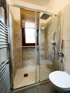 a bathroom with a shower and a toilet at Country Holidays Residence in Santa Maria di Castellabate