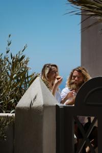 a group of people standing next to a fence at Kastro Mansion in Pyrgos