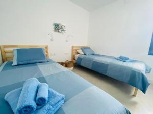 A bed or beds in a room at Apartamento Brumar2 Corralejo Még 10 kép
