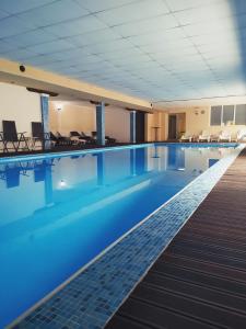 a swimming pool in a hotel with blue water at Hotel Aquastar Danube in Kladovo