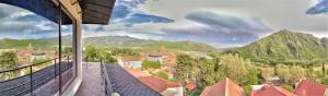 a view of a city from a balcony with mountains at White House Mtskheta in Mtskheta