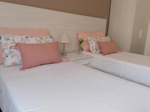 two beds sitting next to each other in a bedroom at Bed da Anna in Peschiera del Garda