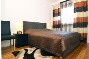 a bedroom with a bed and a window and a rug at Apartment Trnje in Zagreb