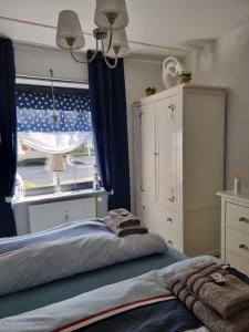 a bedroom with a bed and a large window at bel-appartement-avec-terrasse in Bad Schwartau