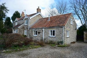 an old stone house with a red roof at Forge Cottage, Helmsley in Helmsley