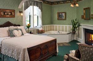 a bedroom with a bed and a bath tub at Old Rittenhouse Inn in Bayfield