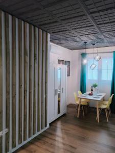 a dining room with a table and a table and chairs at LoL apartment in Alicante