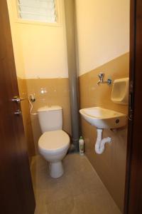 a bathroom with a toilet and a sink at Isramax 3BR apartment near the sea. in Bat Yam