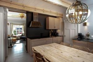 a kitchen with a wooden table and a chandelier at Lilla Sand in Porvoo