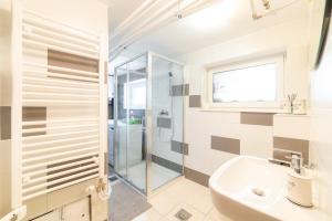 a bathroom with a glass shower and a sink at Bah Apartment in Ljubljana +52 photos
