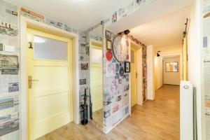 a hallway with a door and a clock on the wall at Bah Apartment in Ljubljana