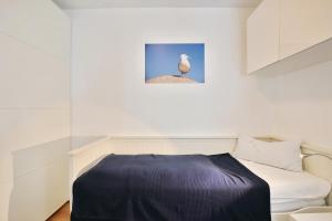 a bedroom with a bed and a bird on the wall at Strandresidenz Timmendorfer Strand Strandresidenz Appartement 101 in Timmendorfer Strand +16 photos