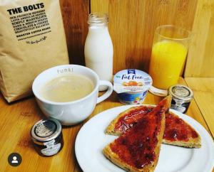 een tafel met een bord toast en een kop melk bij The Fylingdales Inn in Whitby