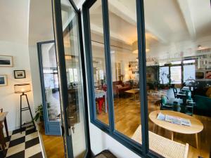 a room with glass doors and a living room at Hotel Saint-Michel in Dinard