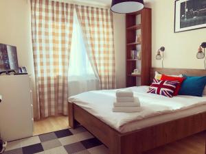 a bedroom with a bed with pillows and a window at Belle View Apartment Brasov in Braşov