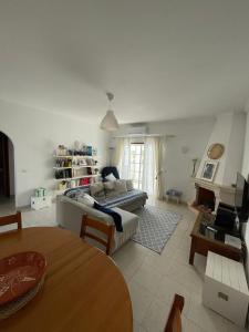 a living room with a couch and a table at Amarguinha in Burgau