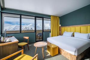 a hotel room with a bed and a large window at Best Western Gudauri in Gudauri