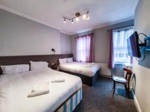Postel nebo postele na pokoji v ubytování Plaza Hotel