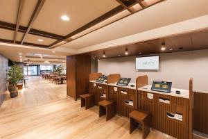 a waiting area in a dental office with tables and chairs at Sotetsu Fresa Inn Kyoto-Kiyomizu Gojo in Kyoto