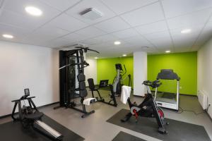 a gym with tread machines and green walls at Résidence Nemea Villeneuve Métropole in Villeneuve d'Ascq +12 photos