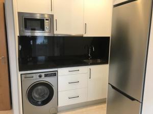 a kitchen with a stainless steel refrigerator and a microwave at Calvario 4 in Vigo