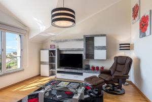 a living room with two chairs and a television at Savana Apartment By Atlantic Holiday in Caniço