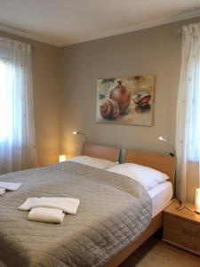 a bedroom with a bed with two towels on it at Villa "Meereslust", Whg 2 in Zingst