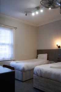 Postel nebo postele na pokoji v ubytování Plaza Hotel
