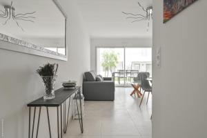 a living room with a couch and a table at T2 NEUF A4 RDJ-PISCINE–ACCÈS DIRECT PLAGES ET CENTRE VILLAGE– in Saint-Cyr-sur-Mer