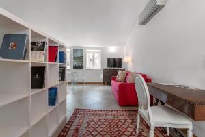 a living room with a table and a red couch at Palazzo Mazzarino in Palermo