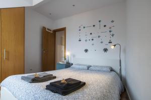 a bedroom with a bed with two towels on it at Central & Typical Lisboa by GT House in Lisbon