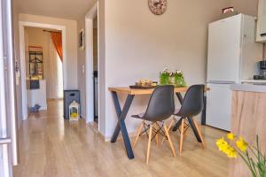 a kitchen with a table and chairs in a kitchen at Mandola Studio Perithia Corfu in Perítheia