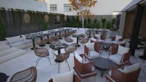a patio with tables and chairs and tablesearcher at M. HOTEL in San Antonio
