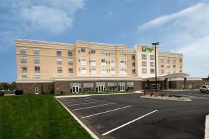 a large building with a parking lot in front of it at Holiday Inn & Suites Detroit - Troy, an IHG Hotel in Troy