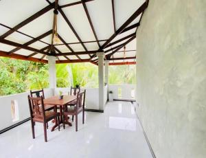 a dining room with a table and chairs at Nilupul Villa in Ambalangoda